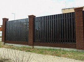 Забор с кирпичными столбами и деревом Забор с кирпичными столбами и деревом